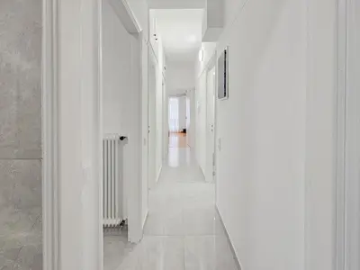 an empty hallway with white walls and white floors at Casa Divas Galaxy Suite in Athens