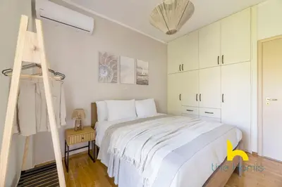 a white bedroom with a bed and a ladder at Turquoise Seashell Retreat Family Oasis N Beach in Vari