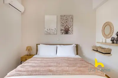 a bedroom with a bed and two pictures on the wall at Turquoise Seashell Retreat Family Oasis N Beach in Vari