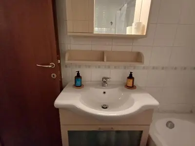 a bathroom sink with two bottles of soap on it at Mary's vintage house in Athens