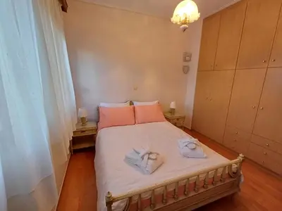 a bedroom with a bed with two towels on it at Mary's vintage house in Athens