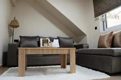 a living room with a couch and a table at 2 Bedroom Home Kallithea - Arhontoula Residences in Athens