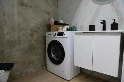 a washing machine in a bathroom with a counter at 2 Bedroom Home Kallithea - Arhontoula Residences in Athens
