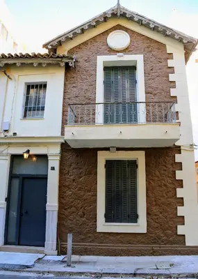a house with a balcony on top of it at 2 Bedroom Home Kallithea - Arhontoula Residences in Athens