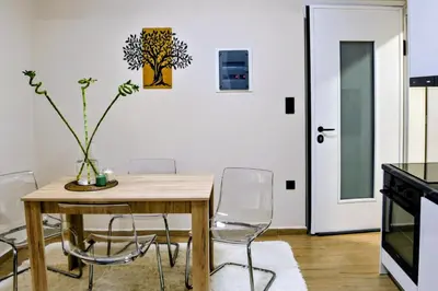 a dining room with a wooden table and chairs at 2 Bedroom Home Kallithea - Arhontoula Residences in Athens