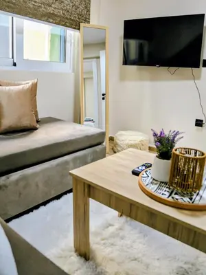 a living room with a couch and a coffee table at 2 Bedroom Home Kallithea - Arhontoula Residences in Athens