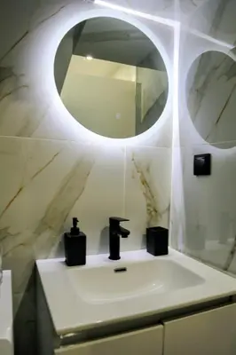 a bathroom with a sink and a mirror at 2 Bedroom Home Kallithea - Arhontoula Residences in Athens