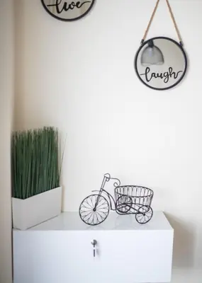 a shelf with a bike and a mirror on it at ANDIE Kallithea Apartment in Athens