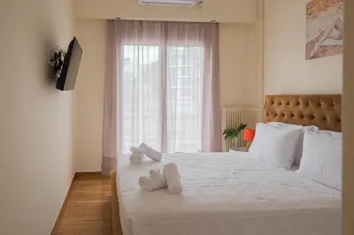 a bedroom with a bed with two stuffed animals on it at ANDIE Kallithea Apartment in Athens