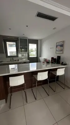 a kitchen with a large counter and two chairs at A decent stay in center Glyfada in Athens