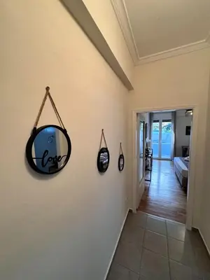 a mirror hanging on a wall in a hallway at Lycabettus Elia in Athens