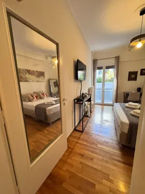 a bedroom with two beds and a large mirror at Lycabettus Elia in Athens