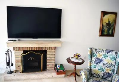 a living room with a tv above a fireplace at Amy's residence in Athens