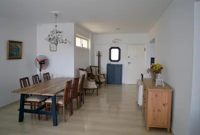 a dining room and living room with a table and chairs at Amy's residence in Athens