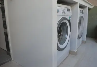 a white washing machine sitting in a room at Amy's residence in Athens