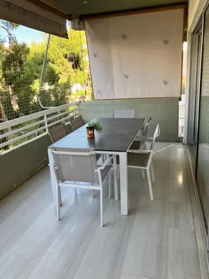 a table and chairs on the balcony of a house at Amy's residence in Athens