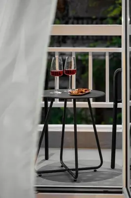 two glasses of red wine sitting on a table at Urban Terra Pangrati by Premium Key in Athens