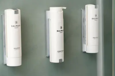 a group of white inhalers hanging on a wall at Urban Terra Pangrati by Premium Key in Athens