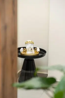a wedding ring on a black table with a wedding cake at Urban Terra Pangrati by Premium Key in Athens