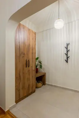a room with a wooden door and a table at Urban Terra Pangrati by Premium Key in Athens