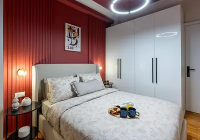 a bedroom with a large bed with red walls at Urban Terra Pangrati by Premium Key in Athens