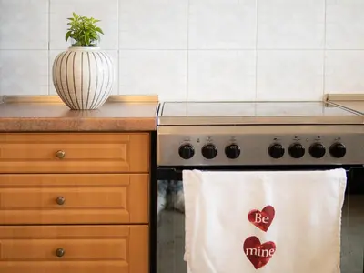 a kitchen with a towel with a heart on the stove at Athens Airport Luxury Apartment in Spáta