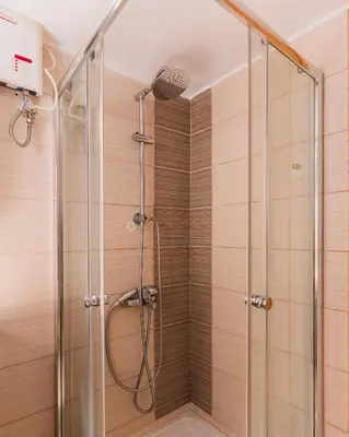 a shower with a glass enclosure in a bathroom at Sweet home in Athens