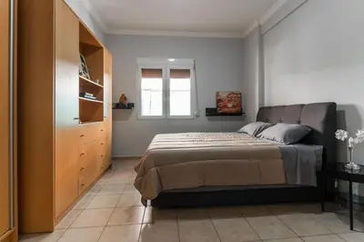 a small bedroom with a bed and a window at Sweet home in Athens