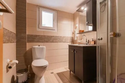 a bathroom with a toilet and a sink at Sweet home in Athens