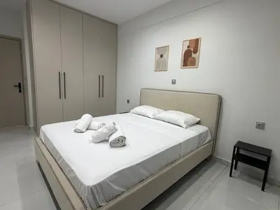 a bedroom with a large bed with towels on it at Urban Comfort Apartment in Athens