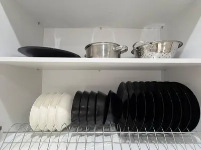a shelf with plates and utensils in a kitchen at Urban Comfort Apartment in Athens
