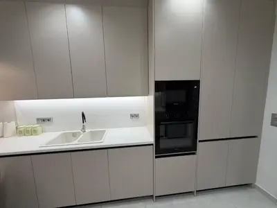 a white kitchen with a sink and a microwave at Urban Comfort Apartment in Athens