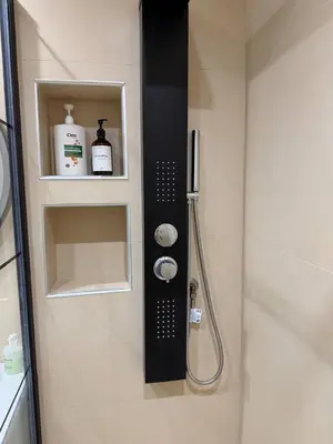 a bathroom with a shower with a showerigunigunuggestuggest at Urban Comfort Apartment in Athens