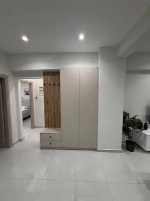 a living room with white walls and white floors at Urban Comfort Apartment in Athens