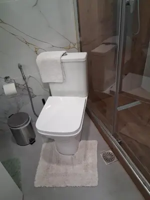 a white toilet in a bathroom with a shower at B2 ACROPOLIs 2 in Athens
