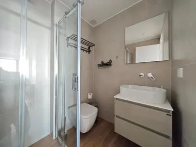 a bathroom with a toilet and a sink and a shower at Costa Elliniko Pool & Beach Sea View DA1 in Athens