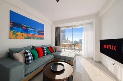a living room with a couch and a table at Costa Elliniko Pool & Beach Sea View DA1 in Athens