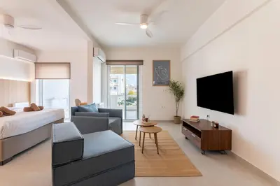a living room with a bed and a tv at La Suite by A&D Properties in Porto Rafti