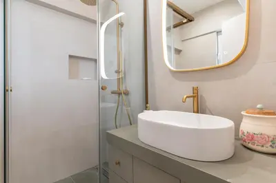 a bathroom with a white sink and a mirror at La Suite by A&D Properties in Porto Rafti
