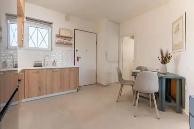 a kitchen and dining room with a table and chairs at La Suite by A&D Properties in Porto Rafti