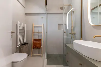 a bathroom with a toilet and a sink and a shower at La Suite by A&D Properties in Porto Rafti