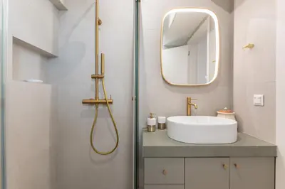a bathroom with a sink and a mirror at La Suite by A&D Properties in Porto Rafti