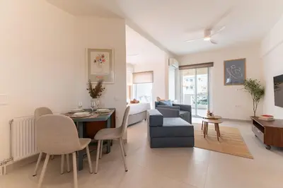 a living room with a table and a dining room at La Suite by A&D Properties in Porto Rafti