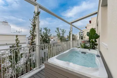 a hot tub on the balcony of a apartment at Athenian Exclusive Penthouse in Athens