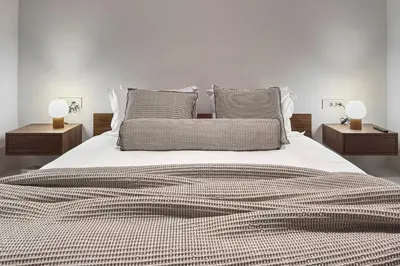 a bedroom with a large bed with two night stands at Athenian Exclusive Penthouse in Athens