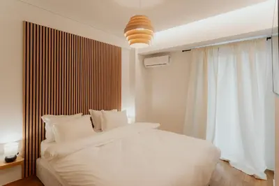 a bedroom with a white bed and a window at 1BR Designer Suite Homey Feel Near Metro in Athens