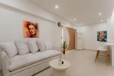 a white living room with a couch and a table at 1BR Designer Suite Homey Feel Near Metro in Athens