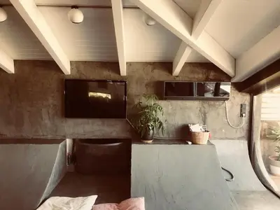 a room with a counter and a tv on a wall at Unique Loft with amazing view TheRampHouse Athens in Athens