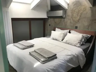 a white bed with towels on top of it at Unique Loft with amazing view TheRampHouse Athens in Athens