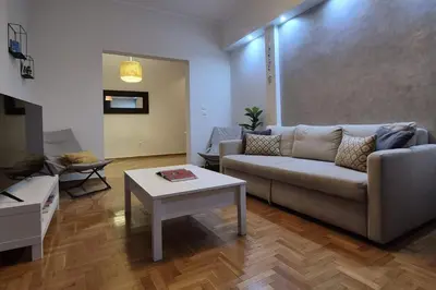 a living room with a couch and a table at Athens Riviera Alimos by Comfort Club in Athens